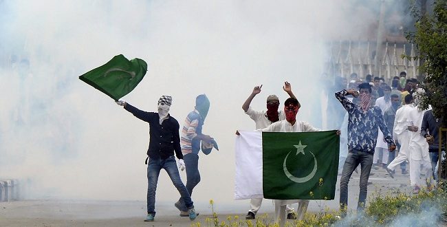 شباب يرفعون علم باكستان خلال الاشتباكات مع القوات الهندية