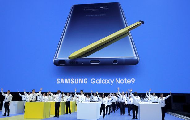 0_Samsung-employees-wave-from-stage-beneath-an-image-of-the-new-Samsung-Galaxy-Note-9-during-a-product