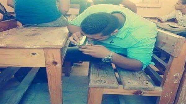 بالصور.. طالب يتعاطى الحشيش  داخل أحد الفصول 